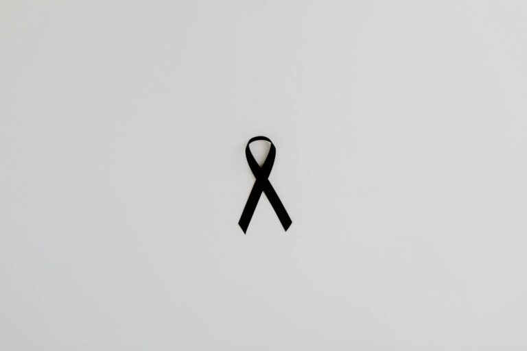 Black awareness ribbon symbolizing support and solidarity on a white background.